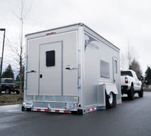 Towing a trailer safely. A Good Trailer hitched to a white truck.