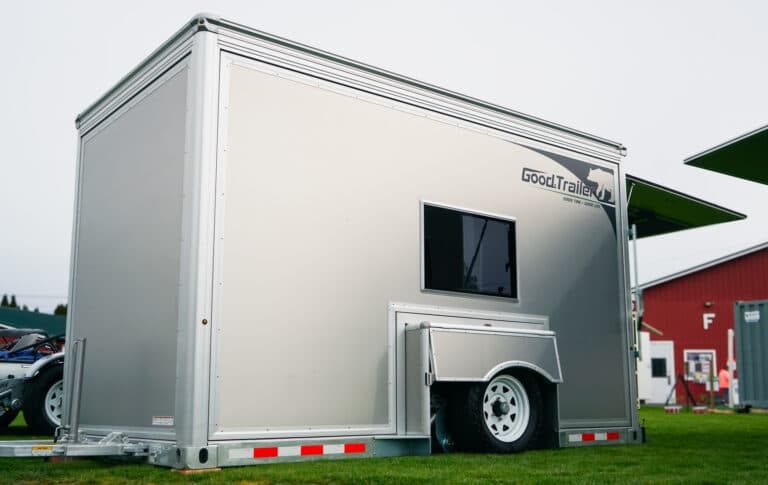 Good trailer outside a barn, lowered to the ground.