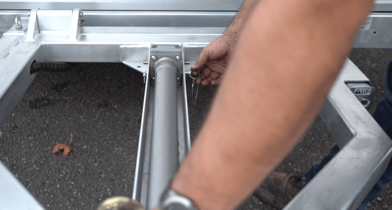 Pulling the detent pin to release the hydraulic piston on a GoodTrailer.
