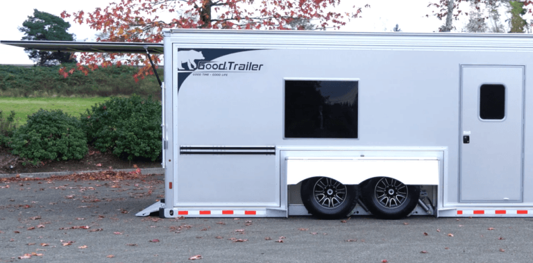 A trailer with an open lift door and lowered ramp.