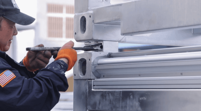 A GoodMFG employee secures the corner casters.