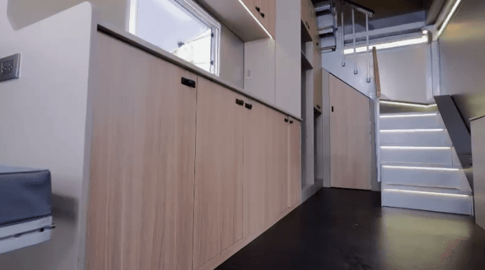 The counter, cabinets, and stairwell inside the bottom floor of the Stackable Trailer.