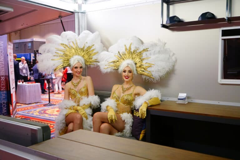 Show girls in a modular structure green room