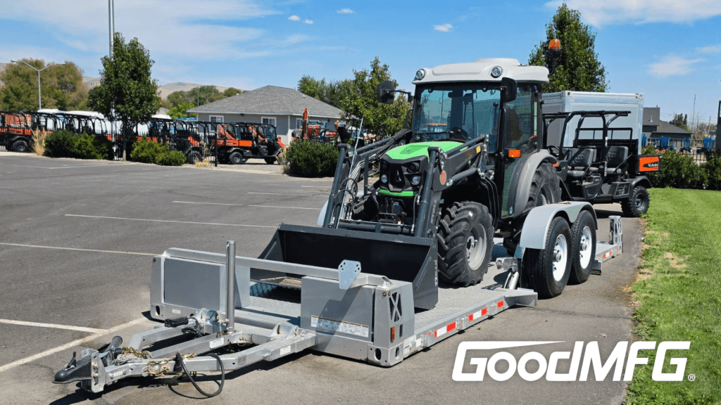 Heavy equipment on flatbed trailer - tractor hauling trailer flatbed drop deck on the ground.