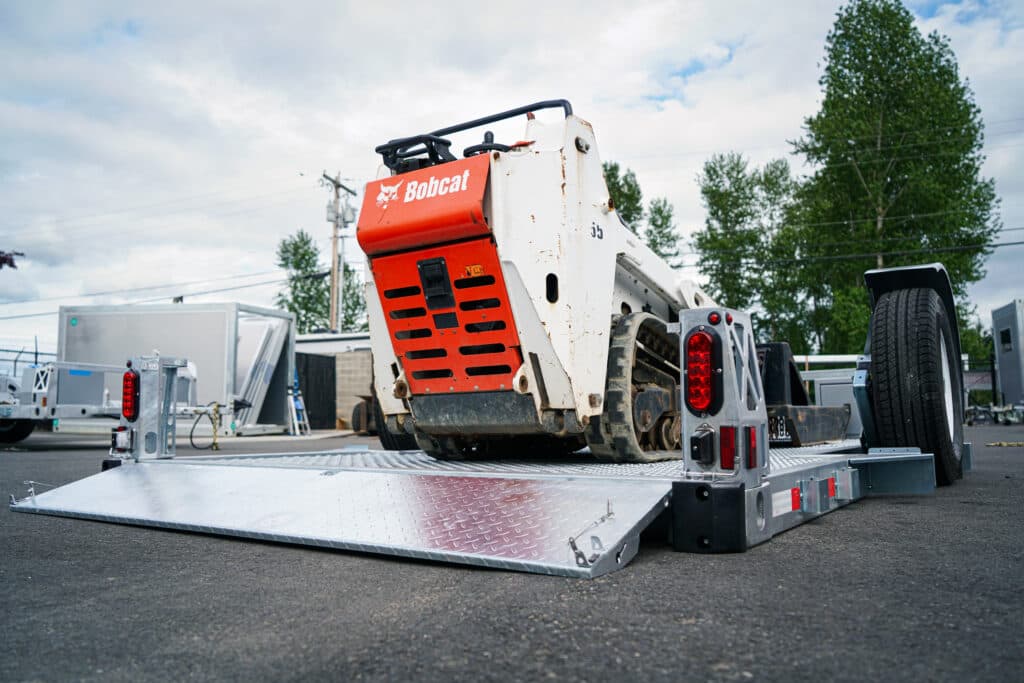 Bobcat On Hydraulic Drop Deck Flatbed Trailer