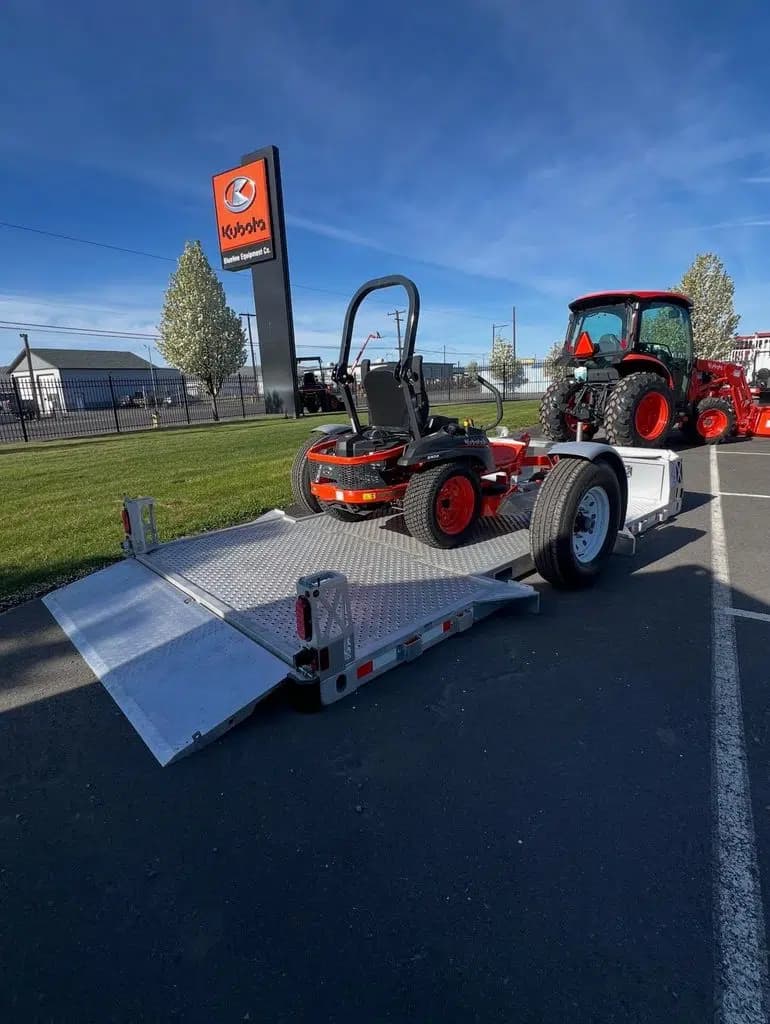 Landscaping trailer - Mower loaded at ground level on a 13' drop deck flatbed trailer.