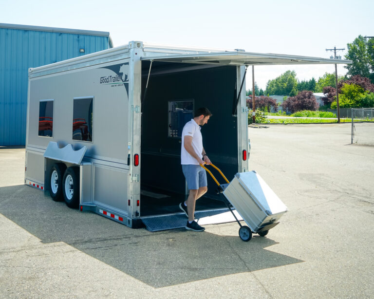 Man loads cargo into Good trailers and modular structures