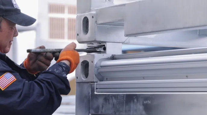 A GoodMFG employee secures the corner casters.