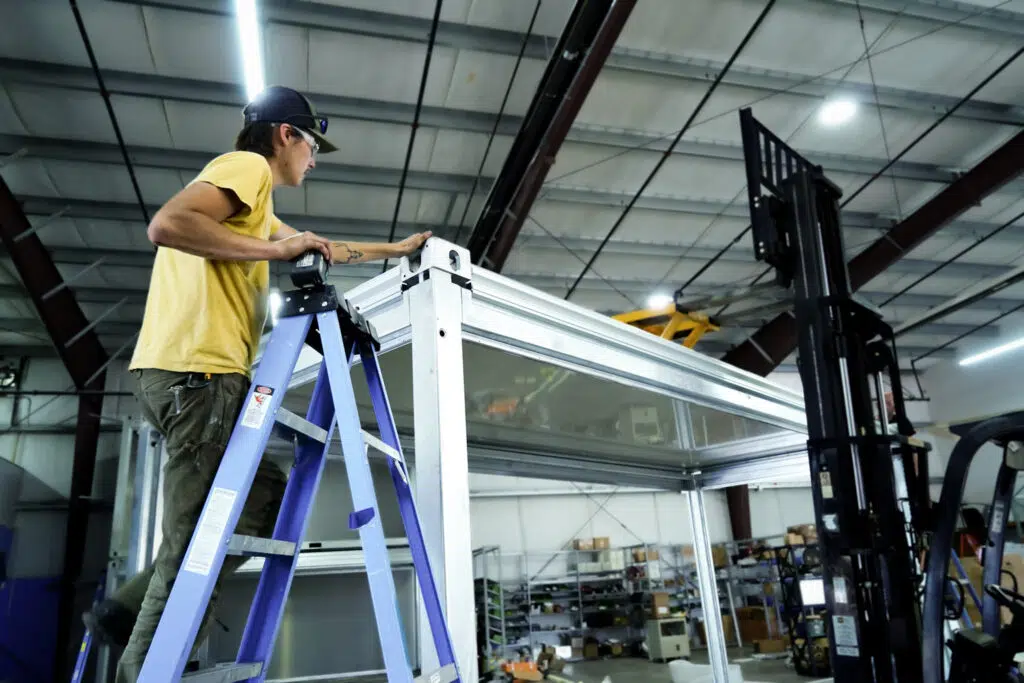 A GoodMFG Worker on a Ladder
